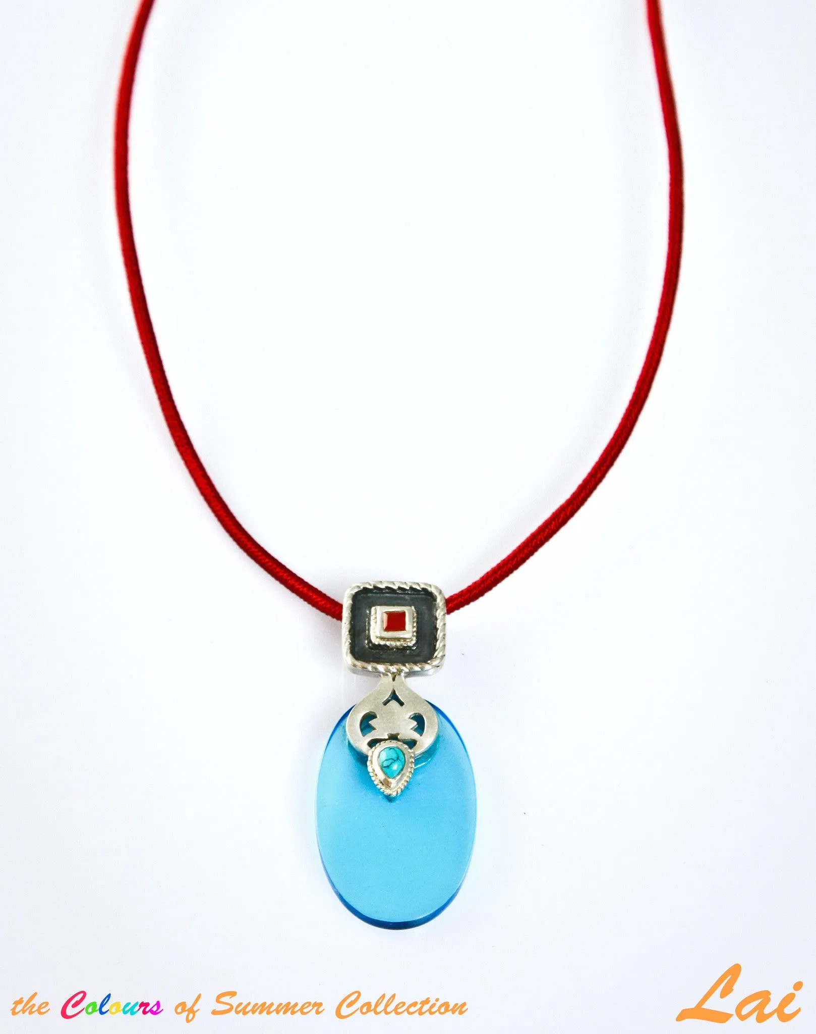 Chic, oval blue glass pendant with silver, turquoise and carnelian detailing